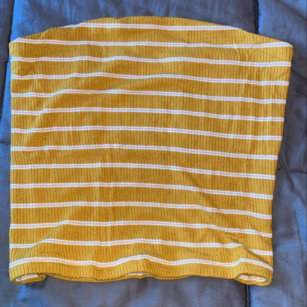 Mustard yellow sleeveless crop top.